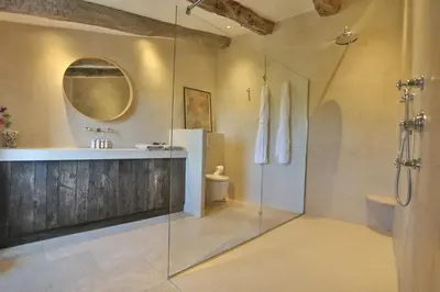 a bathroom with a shower and a sink and a mirror at Character House In The Heart Of Gordes in Gordes