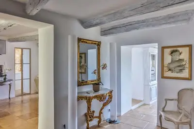 a room with a mirror and a table and a chair at Character House In The Heart Of Gordes in Gordes