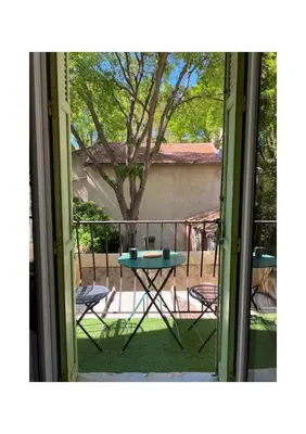 a view of a table and chairs from a window at Studio avec balcon sur cour in Aix-en-Provence