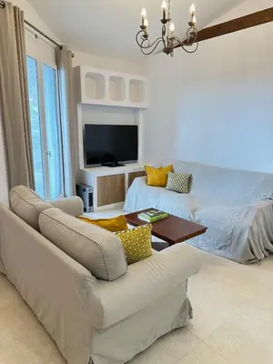 a living room with a couch and a bed at Le Grand Bouteillan in Pierrevert