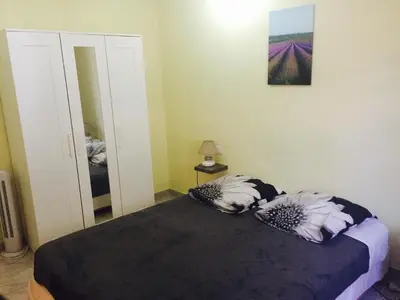 a bedroom with a bed with two pillows and a mirror at Villa les Lauriers in Lioux