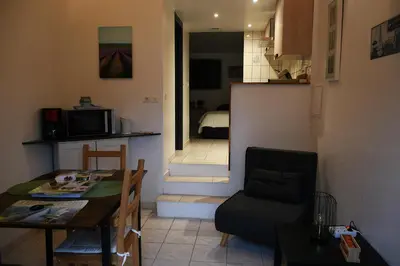 a living room with a table and a dining room at Villa les Lauriers in Lioux