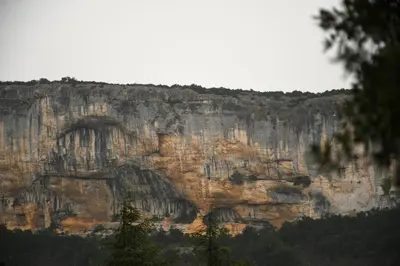a rocky mountain with trees in front of it at Villa les Lauriers in Lioux