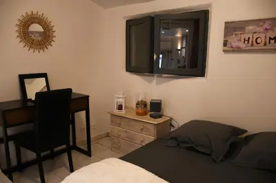 a bedroom with a bed and a desk and a mirror at Villa les Lauriers in Lioux