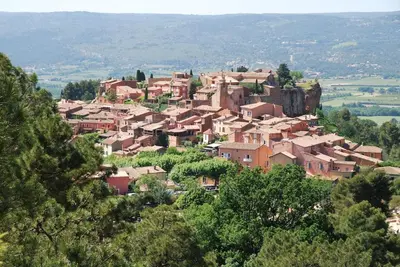 a village on a hill with houses on it at Le Jardin d'Auguste in Roussillon
