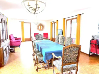 a dining room with a blue table and chairs at Le Jardin d'Auguste in Roussillon