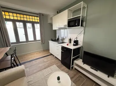 a small kitchen with a sink and a stove at Cocon T2 dans le centre d'Aix in Aix-en-Provence