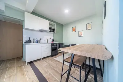 a kitchen with a wooden table in a room at Cocon T2 dans le centre d'Aix in Aix-en-Provence