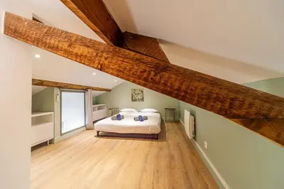 a bedroom with a large bed in a attic at T4 d'exception à Aix in Aix-en-Provence