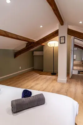 a bedroom with a white bed and a lamp at T4 d'exception à Aix in Aix-en-Provence