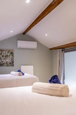 a bedroom with two beds and a window at T4 d'exception à Aix in Aix-en-Provence