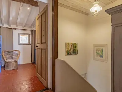 a hallway with an open door and a chair at Holiday Home Côté Place by Interhome in Villars