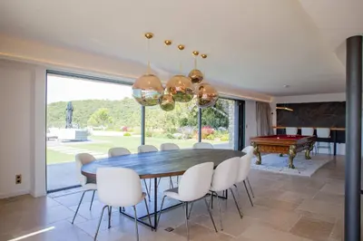 a dining room with a table and chairs and a pool table at Luxury 4-bedroom villa - pool in Gordes