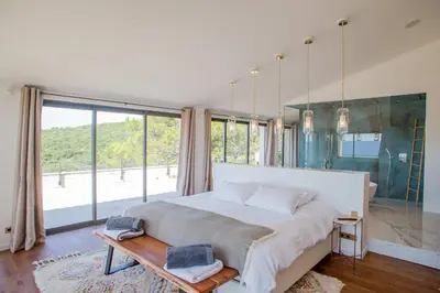 a bedroom with a large bed and a large window at Luxury 4-bedroom villa - pool in Gordes