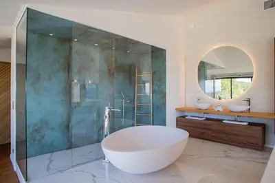 a bathroom with a tub and a glass shower at Luxury 4-bedroom villa - pool in Gordes