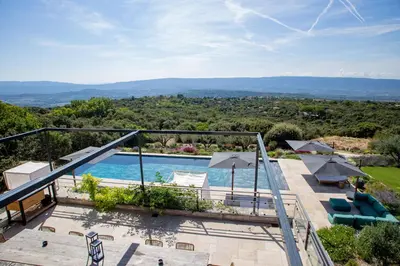 a view from the balcony of a house with a swimming pool at Luxury 4-bedroom villa - pool in Gordes
