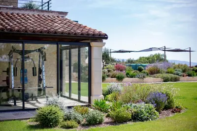 a gazebo with glass doors in a garden at Luxury 4-bedroom villa - pool in Gordes