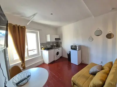 a living room with a couch and a table at Cosy downtown studio in Apt