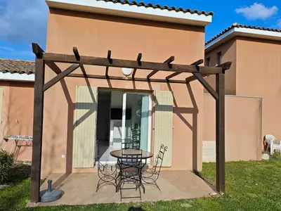 a wooden pergola with a table and chairs on a patio at Casa Luma in Saint-Saturnin-les-Avignon