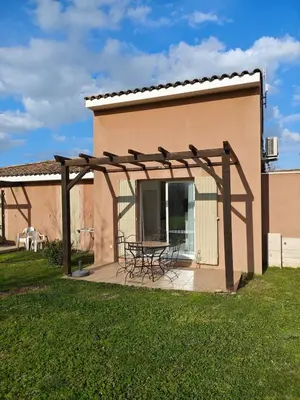 a patio with a table and chairs under a pergola at Casa Luma in Saint-Saturnin-les-Avignon