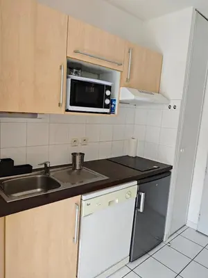 a small kitchen with a sink and a microwave at Casa Luma in Saint-Saturnin-les-Avignon