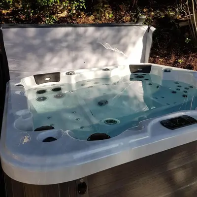 a jacuzzi bathtub in the ground with water in it at La Cabane Aixoise Piscine & Jacuzzi in Aix-en-Provence