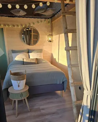 a bedroom with a bed and a ladder at La Cabane Aixoise Piscine & Jacuzzi in Aix-en-Provence