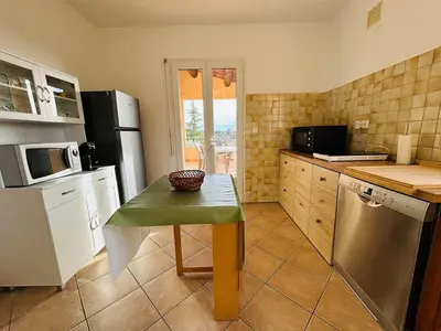a kitchen with a small table and a microwave at Villa dans le Luberon in Saint-Saturnin-les-Apt