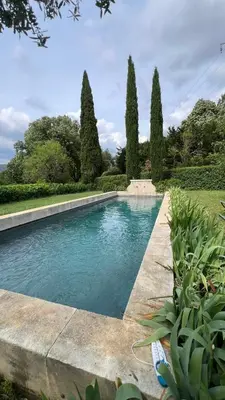 a swimming pool in a garden with trees at Holiday Home in Lourmarin Stunning View of the Château in Lourmarin