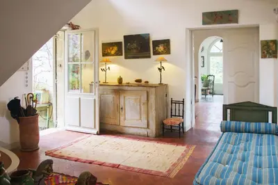 a living room with a couch and an open door at Holiday Home in Lourmarin Stunning View of the Château in Lourmarin