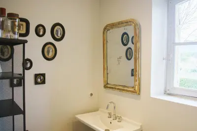 a bathroom with a mirror and a sink at Holiday Home in Lourmarin Stunning View of the Château in Lourmarin