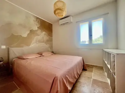 a bedroom with a bed with a painting on the wall at Maison du Ventoux in Mormoiron