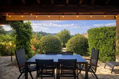 a blue table and chairs on a patio at Maison du Ventoux in Mormoiron