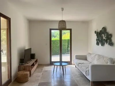 a living room with a couch and a table at Maison du Ventoux in Mormoiron