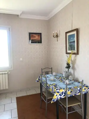 a dining room table with a blue and white table cloth at Jolie studio en Provence! in Pierrevert