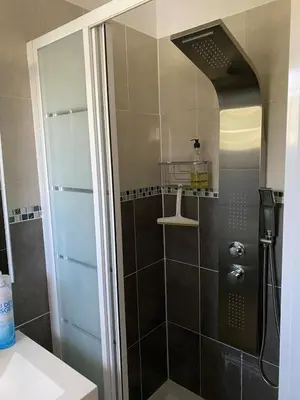 a shower with a glass door in a bathroom at Chez Cathy in Pernes-les-Fontaines