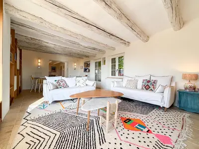 a living room with two white couches and a table at Mas des Collines in Saint-Hippolyte-le-Graveyron
