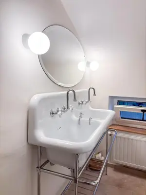 a bathroom with a sink and a mirror at Mas des Collines in Saint-Hippolyte-le-Graveyron