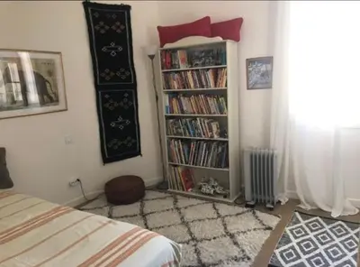 a bedroom with a book shelf filled with books at 100m2 beautiful appartment in Aix City Center in Aix-en-Provence