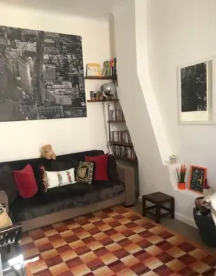 a living room with a couch and a stair case at 100m2 beautiful appartment in Aix City Center in Aix-en-Provence