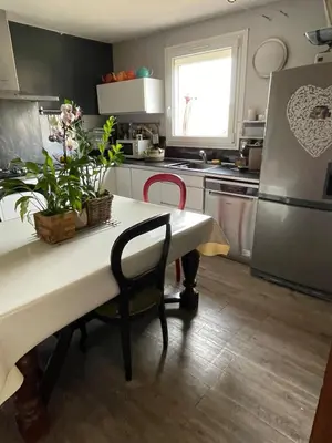 a kitchen with a table and a refrigerator at Zen house with a view in Manosque
