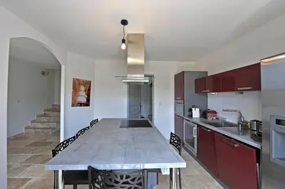 a kitchen with a large table in the middle at Villa Doce Lar in Lioux