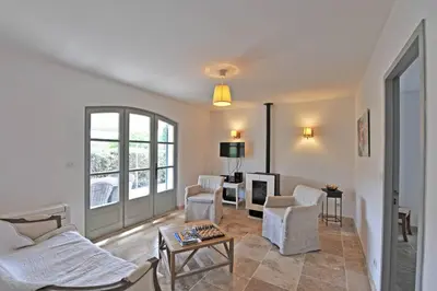 a living room with a couch and chairs and a table at Villa Doce Lar in Lioux