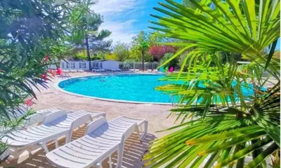 a swimming pool with chaise lounge chairs and a swimming pool at Comme Chez Vous Au Camping Des Iscles in La Roque-dʼAnthéron