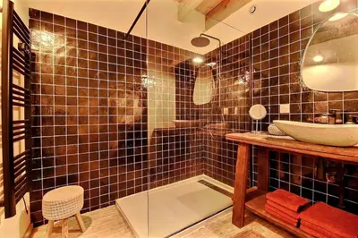 a bathroom with a sink and a mirror at Le Mas Rose Thé in Robion en Luberon