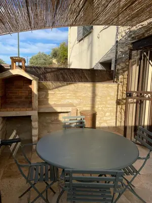 a table and chairs sitting on a patio at Maison du soleil in Caumont-sur-Durance