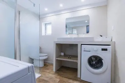 a bathroom with a washing machine and a toilet at Domaine Manon en Luberon privatisé - 22 couchages in Lagnes