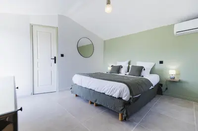 a bedroom with a large bed and a mirror at Domaine Manon en Luberon privatisé - 22 couchages in Lagnes