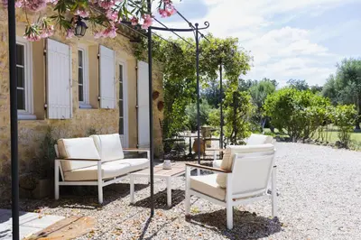 a group of chairs and a table on a patio at Domaine Manon en Luberon privatisé - 22 couchages in Lagnes