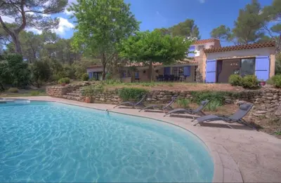 a swimming pool with chairs and a house at Villa Martine, authentic family home in Rognes